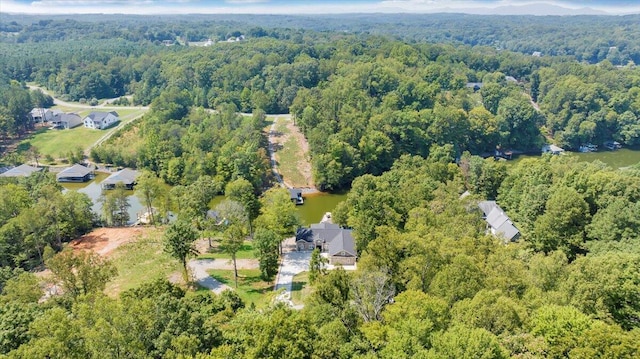 drone / aerial view featuring a wooded view