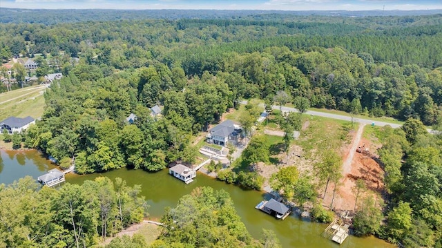 drone / aerial view featuring a forest view and a water view