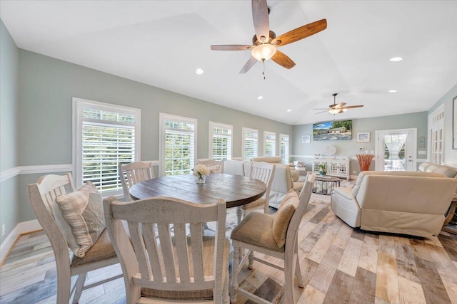 dining space with lofted ceiling, light wood finished floors, baseboards, and recessed lighting