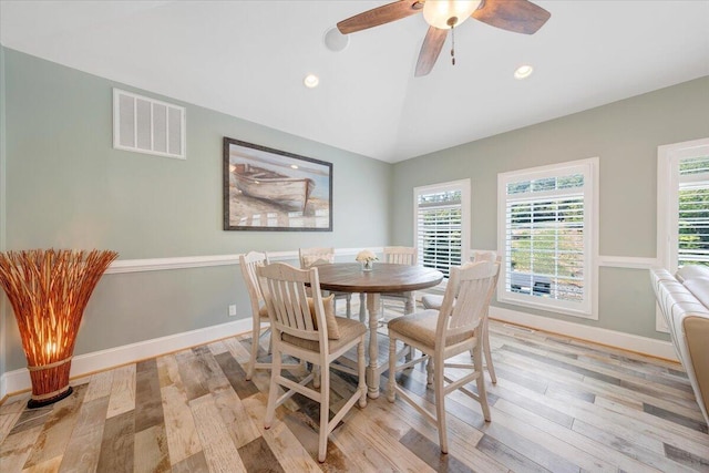 dining space with recessed lighting, visible vents, light wood-style flooring, vaulted ceiling, and baseboards