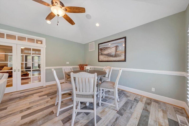 dining area featuring visible vents, baseboards, lofted ceiling, french doors, and light wood-type flooring