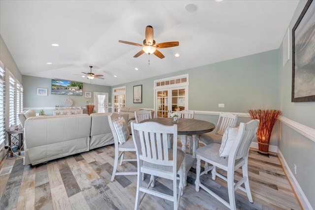 dining room featuring vaulted ceiling, french doors, light wood finished floors, and baseboards