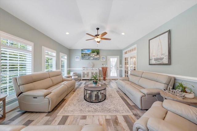 living area featuring light wood-style floors, lofted ceiling, plenty of natural light, and recessed lighting