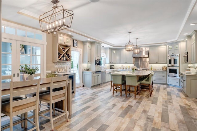 kitchen featuring an inviting chandelier, gray cabinets, pendant lighting, and a center island