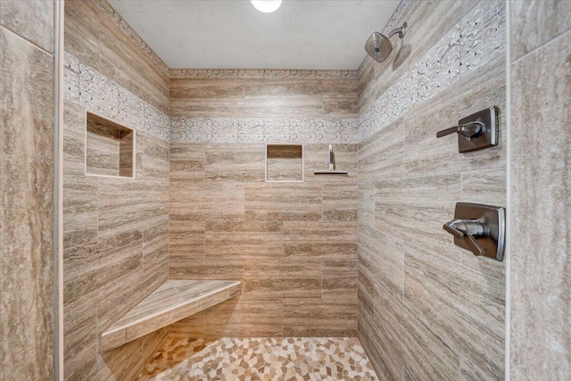 full bathroom featuring tiled shower