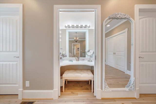 hallway featuring light wood-style floors and baseboards