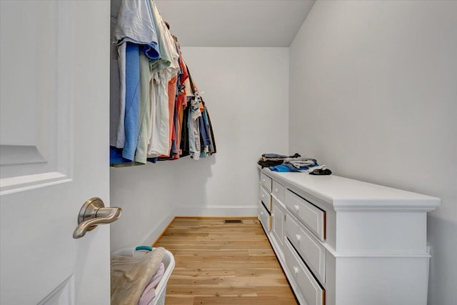 walk in closet with light wood-type flooring