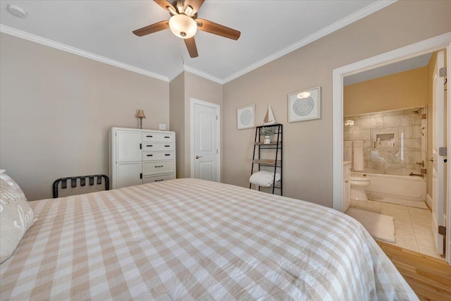 bedroom with ensuite bath, a ceiling fan, crown molding, and wood finished floors