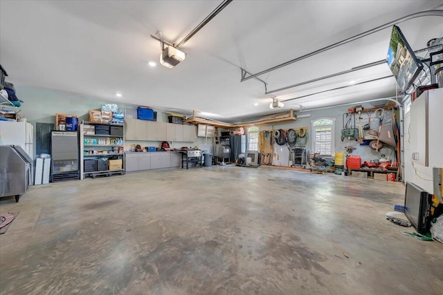 garage with a garage door opener and a workshop area