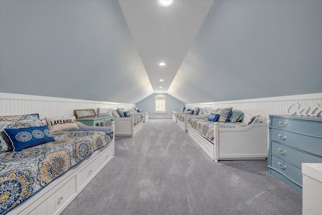 bedroom featuring lofted ceiling, wainscoting, light carpet, and recessed lighting