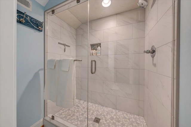 full bath with a stall shower and visible vents