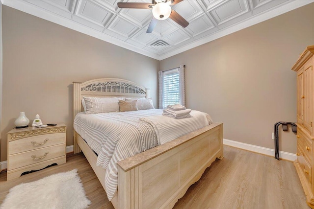 bedroom with visible vents, baseboards, a ceiling fan, an ornate ceiling, and light wood-type flooring