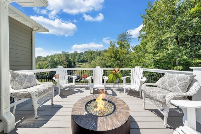 wooden terrace with an outdoor fire pit