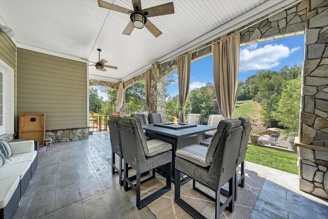 sunroom featuring ceiling fan