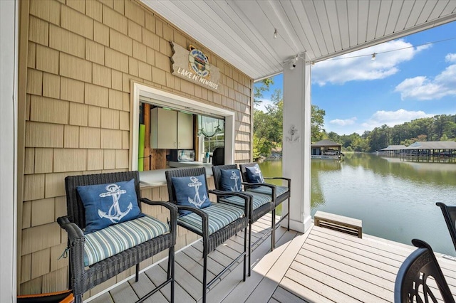 wooden terrace featuring a water view