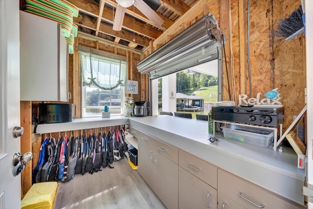 interior space with white cabinets, light countertops, and light wood finished floors