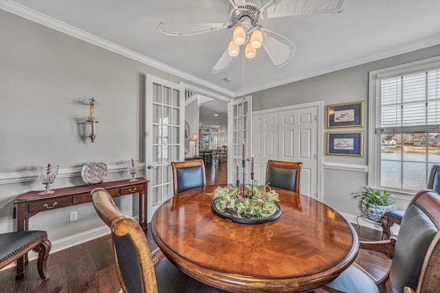 dining area featuring baseboards, a ceiling fan, wood finished floors, crown molding, and french doors