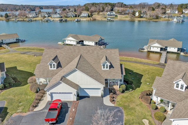 birds eye view of property featuring a water view and a residential view