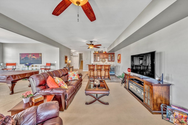 carpeted living room featuring ceiling fan