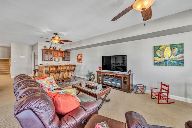 living room with carpet floors, bar, and baseboards