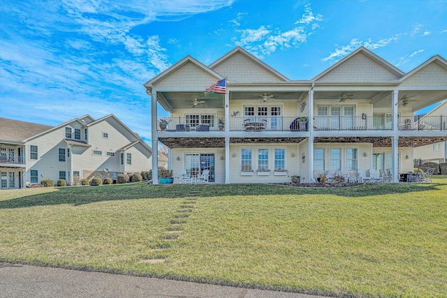 view of front of home with a balcony and a front yard