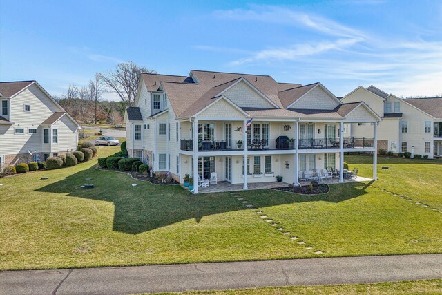 view of front facade featuring a front yard, french doors, and a patio