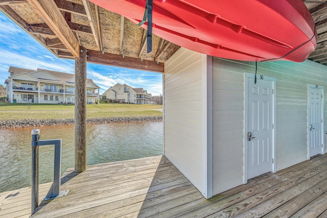 view of dock featuring a water view and a residential view