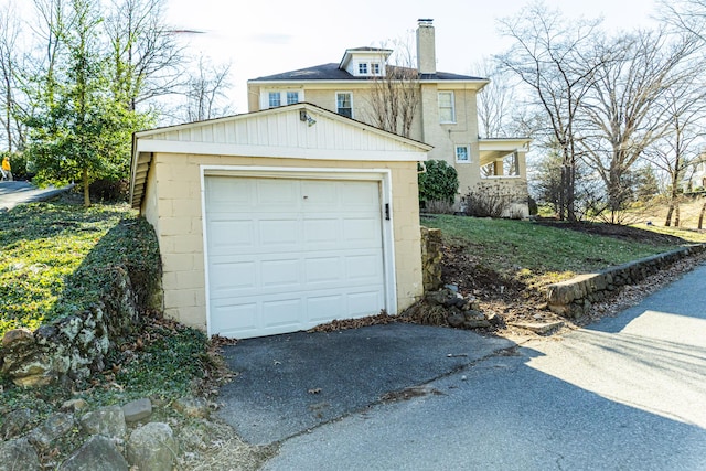 detached garage with aphalt driveway