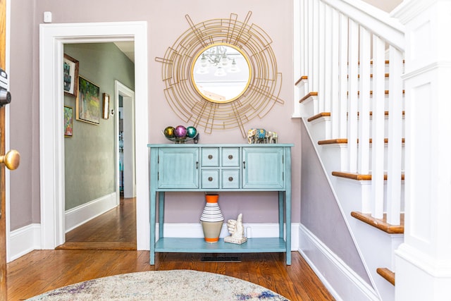 interior space featuring baseboards and wood finished floors