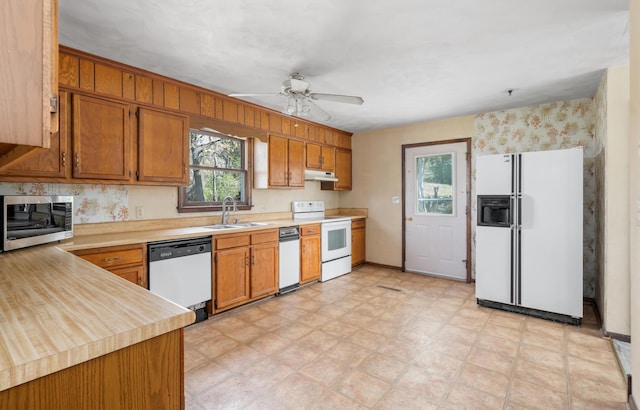 42 Keswick Ct, Troutville, VA 24175 - kitchen with light countertops, a ceiling fan, a sink, white appliances, and brown cabinetry