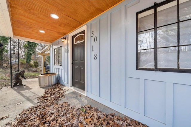 entrance to property featuring board and batten siding and covered porch