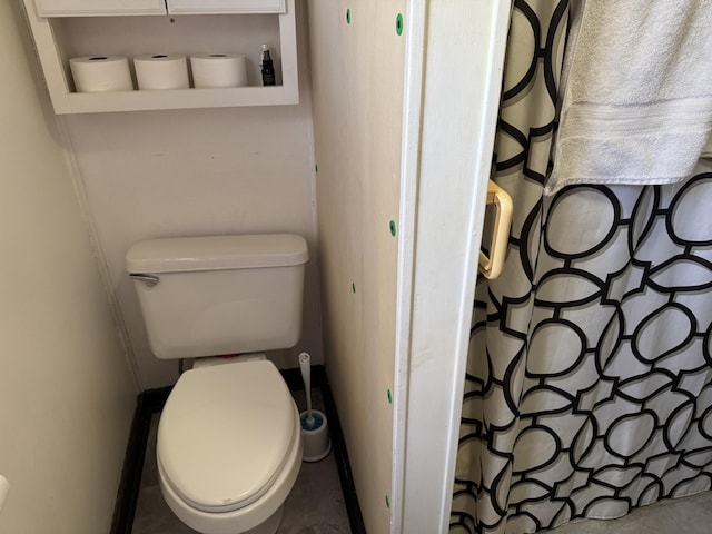 bathroom featuring toilet and a shower with curtain