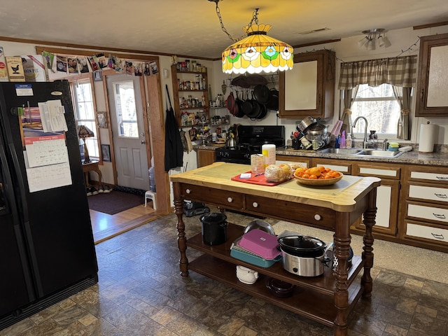 kitchen with black appliances, a sink, visible vents, and a healthy amount of sunlight