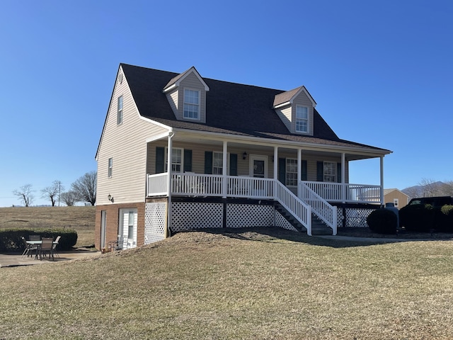 view of front of home with a patio, a porch, and a front yard