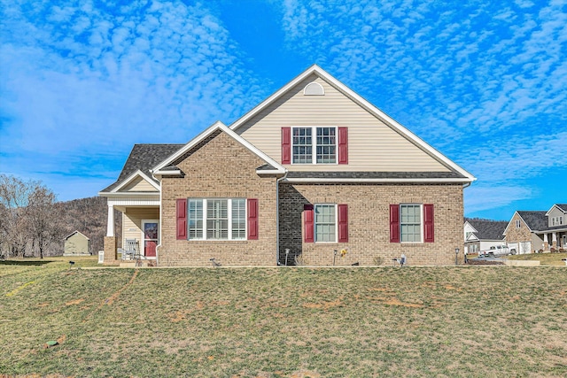 traditional-style home with a front yard and brick siding