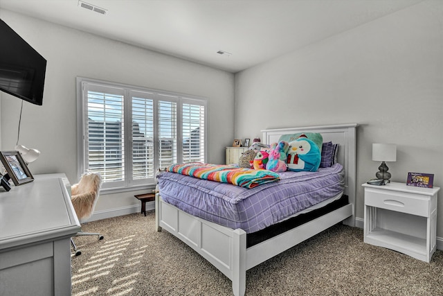 carpeted bedroom featuring baseboards and visible vents