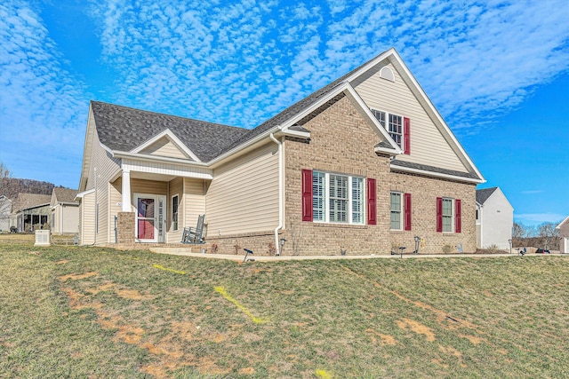 view of front of house with brick siding and a front yard