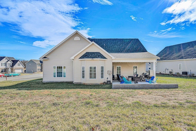 back of house with a yard, a shingled roof, cooling unit, and a patio