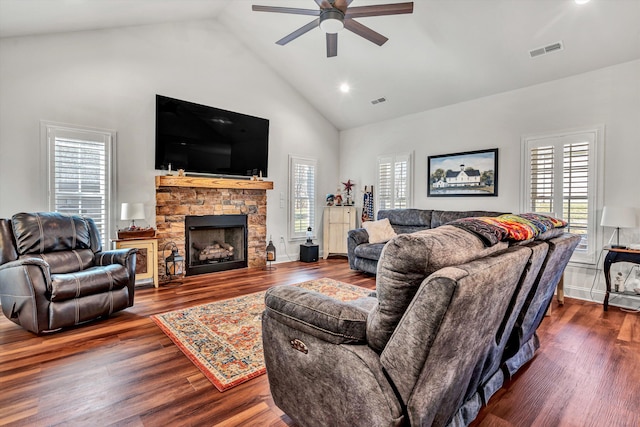 living room featuring a healthy amount of sunlight, visible vents, and wood finished floors