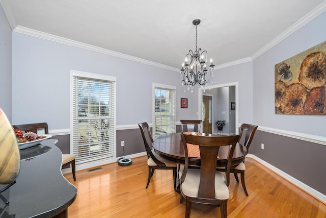 56 Savannah Ct, Daleville, VA 24083 - dining room with visible vents, light wood-type flooring, crown molding, baseboards, and a chandelier