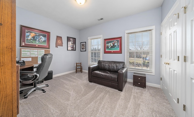 office space featuring carpet, visible vents, and baseboards