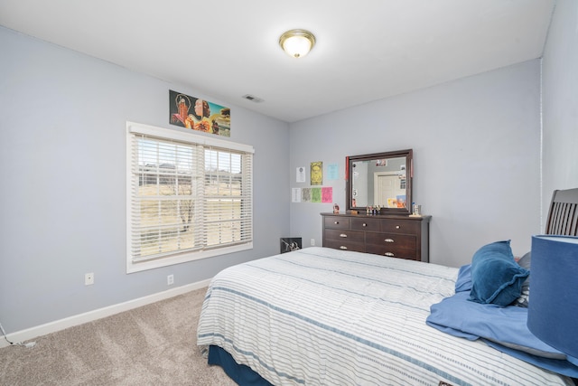 carpeted bedroom featuring baseboards and visible vents