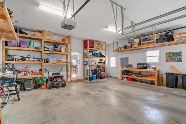 garage featuring a garage door opener and a workshop area