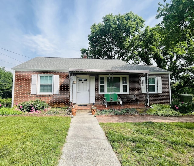 23 Upland Dr, Salem, VA 24153 - view of front facade featuring brick siding, a porch, a front yard, and a chimney