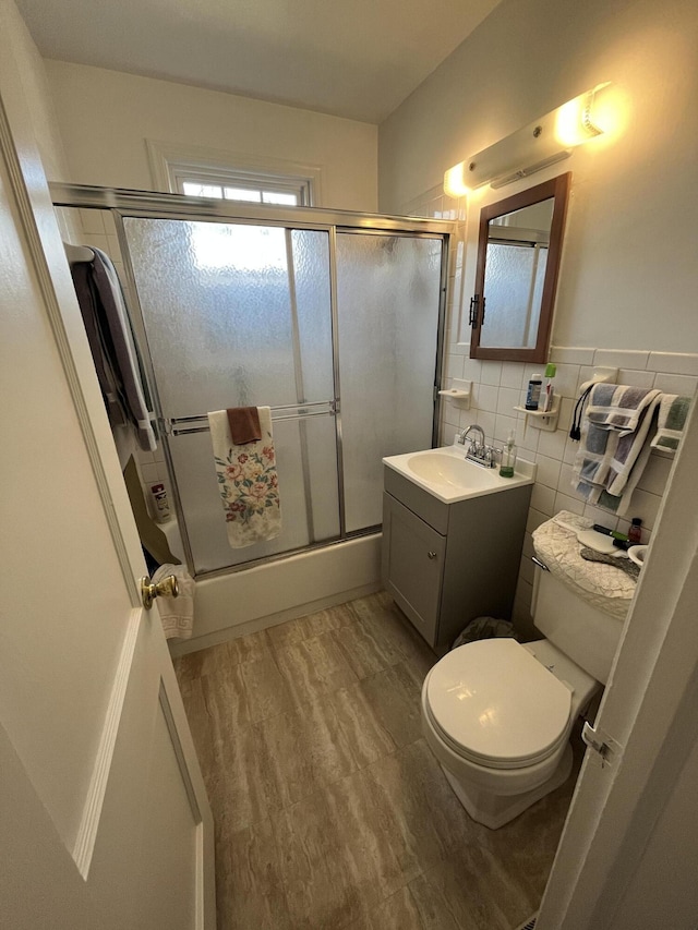 23 Upland Dr, Salem, VA 24153 - bathroom featuring a shower with shower door, vanity, toilet, tile walls, and wood finished floors