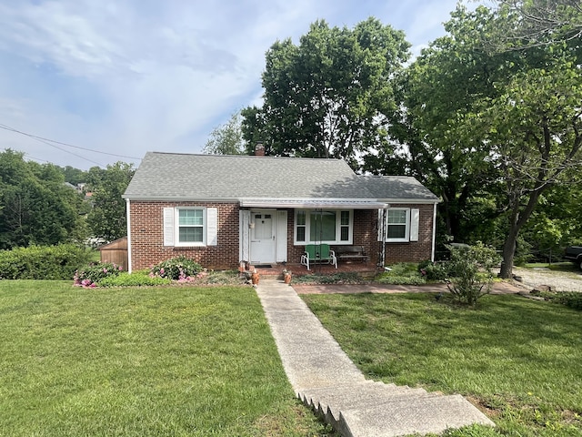 23 Upland Dr, Salem, VA 24153 - view of front of home with covered porch, brick siding, a front lawn, a chimney, and a shingled roof