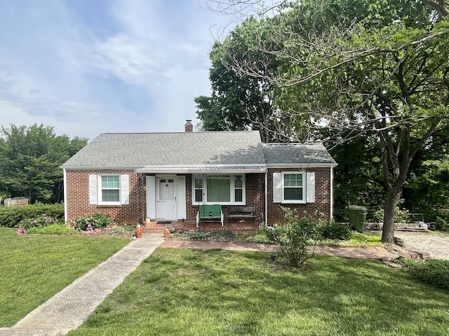 23 Upland Dr, Salem, VA 24153 - bungalow featuring brick siding, a front lawn, a shingled roof, and a chimney
