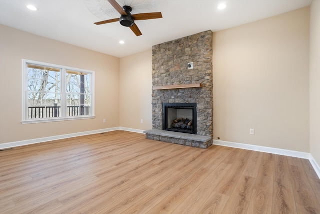 unfurnished living room featuring a fireplace, light wood finished floors, recessed lighting, ceiling fan, and baseboards