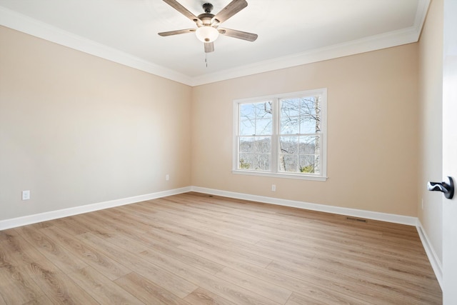 empty room with baseboards, ornamental molding, a ceiling fan, and light wood-style floors