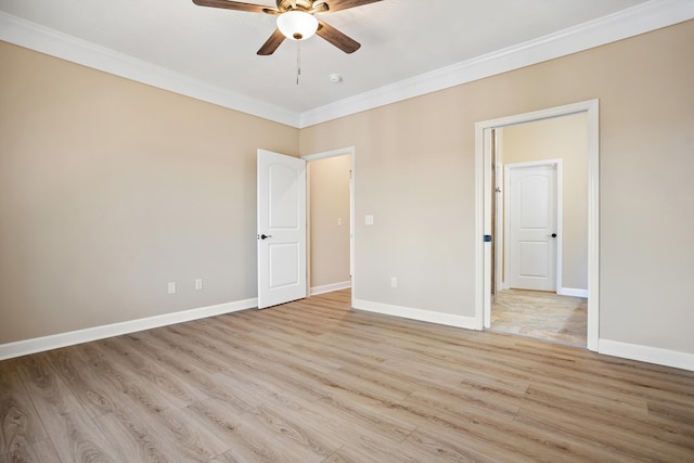 spare room featuring baseboards, crown molding, light wood finished floors, and ceiling fan